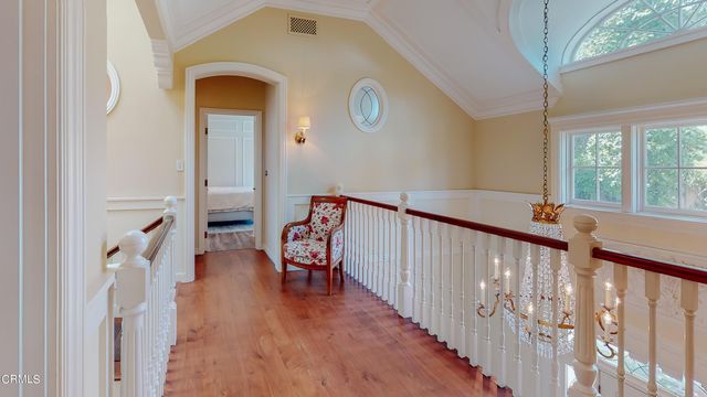a large white kitchen with a sink and a large mirror
