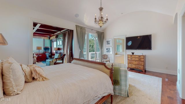 a bedroom with a bed and a chandelier