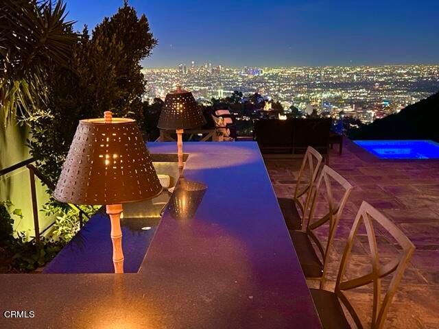 a view of a house with swimming pool and sitting area