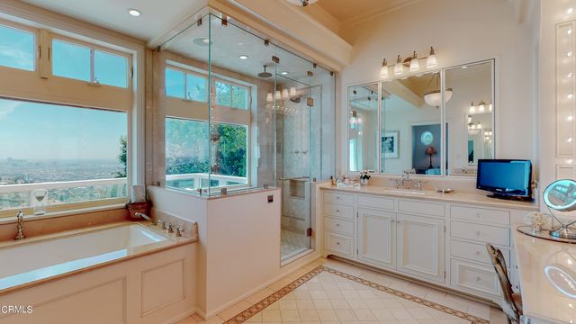 an aerial view of residential houses with outdoor space and trees