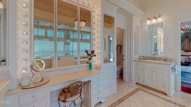 a view of a patio with table and chairs potted plants and large tree