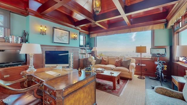 a view of swimming pool with outdoor seating and mountain in the back