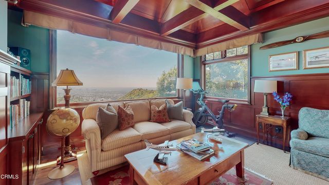 an aerial view of a house with a yard and large trees