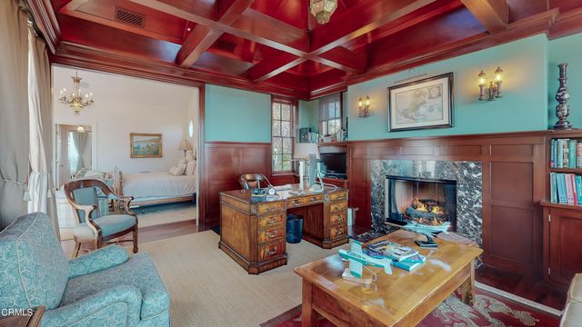 an aerial view of a house with swimming pool a yard and patio