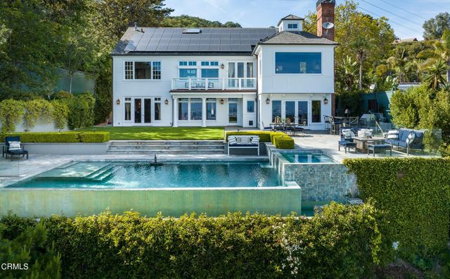 an aerial view of a house with a yard