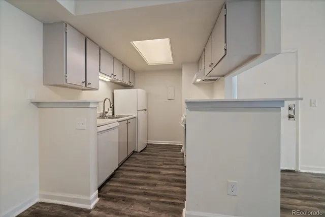 a kitchen with cabinets and white stainless steel appliances