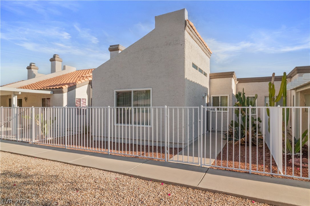 2146 High Dunes Lane Laughlin, NV 89029 - Photo 39 of 64 View of side of home featuring stucco siding, fence, and a tile roof