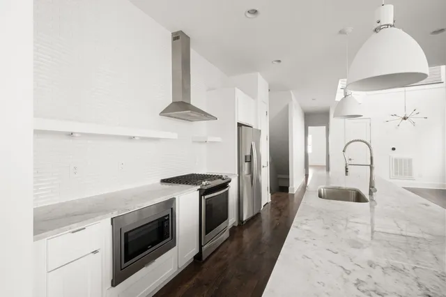 a kitchen with stainless steel appliances a stove and a refrigerator