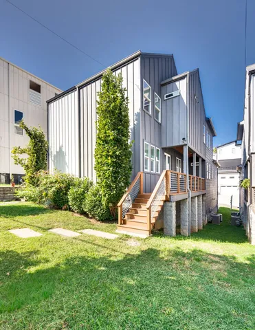 a view of a house with backyard and sitting area