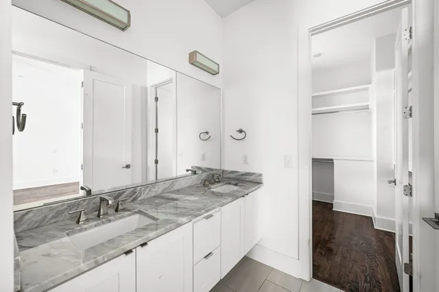 a bathroom with a granite countertop sink and a mirror