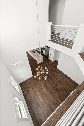 an empty room with windows and ceiling fan