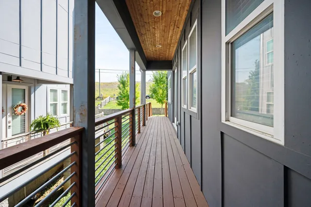 a view of balcony with wooden floor