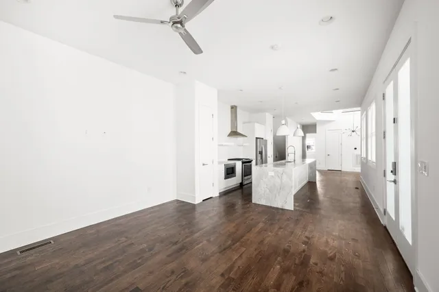 a view of empty room with wooden floor