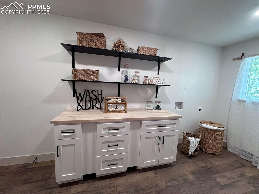 14546 Pine View Road Larkspur, CO 80118 - Photo 13 of 37 Bar with dark wood finished floors