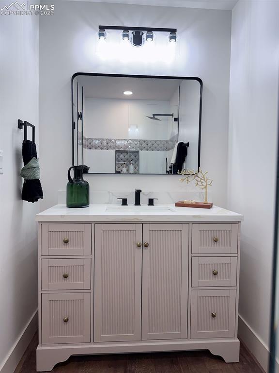 14546 Pine View Road Larkspur, CO 80118 - Photo 23 of 37 Full bath featuring vanity, wood finished floors, and a shower