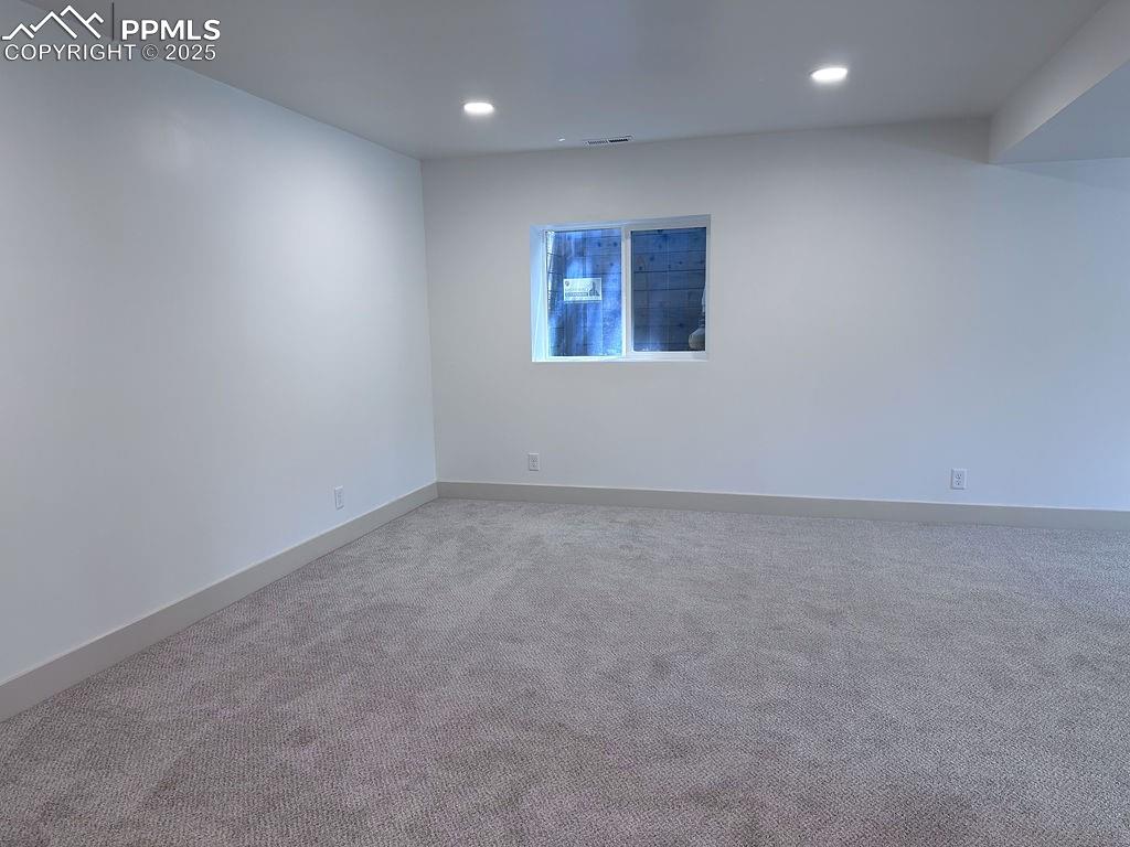 14546 Pine View Road Larkspur, CO 80118 - Photo 27 of 37 Carpeted spare room with recessed lighting