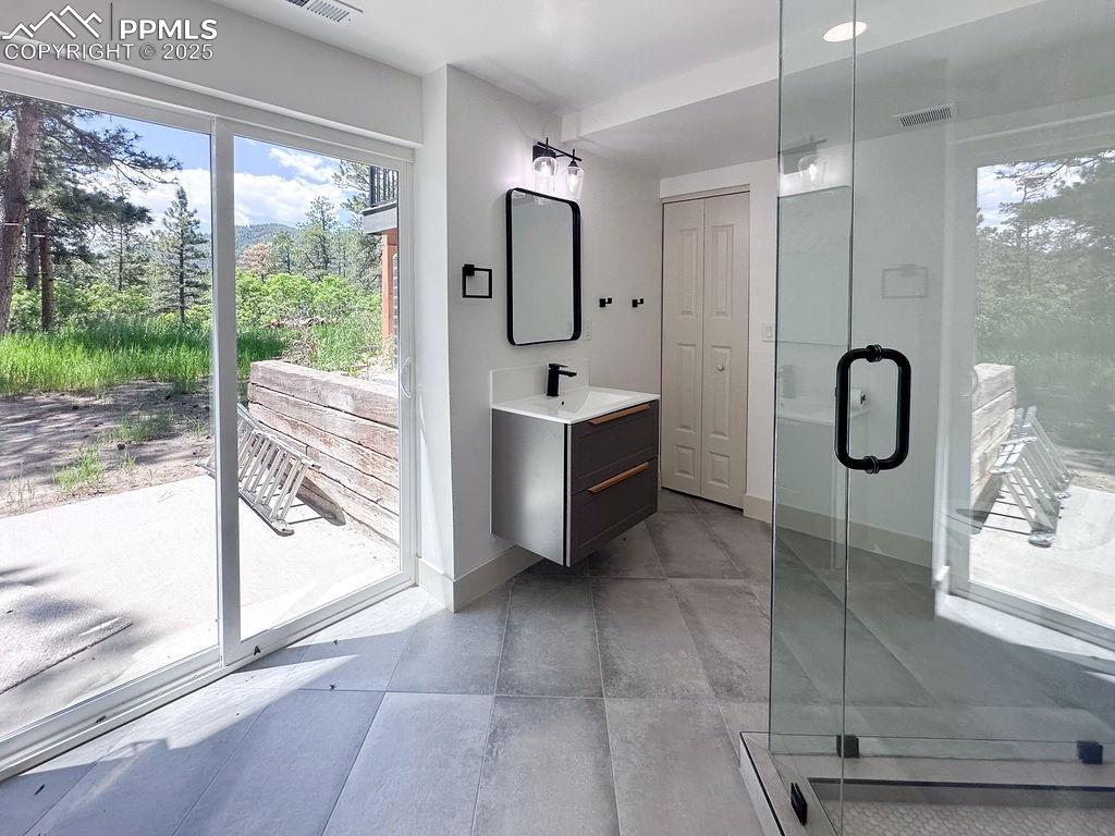 14546 Pine View Road Larkspur, CO 80118 - Photo 30 of 37 Full bathroom with vanity and a stall shower