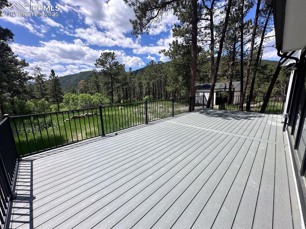 14546 Pine View Road Larkspur, CO 80118 - Photo 35 of 37 Deck with a view of trees