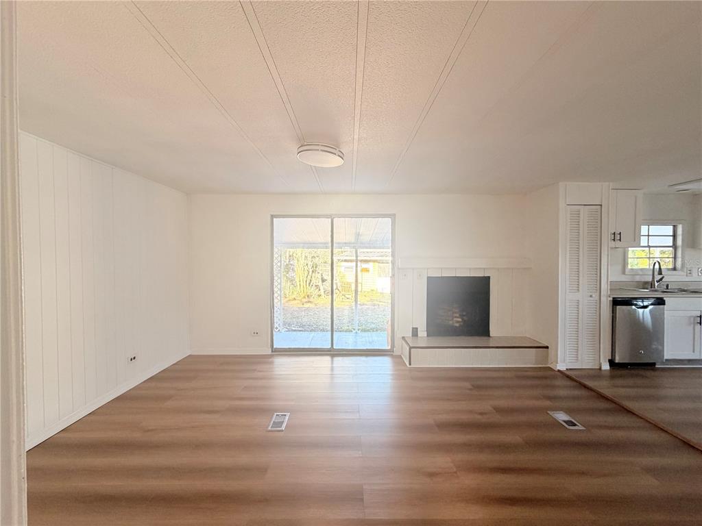 26352 Mc Allister Street Brooksville, FL 34602 - Photo 13 of 26 a view of empty room with wooden floor