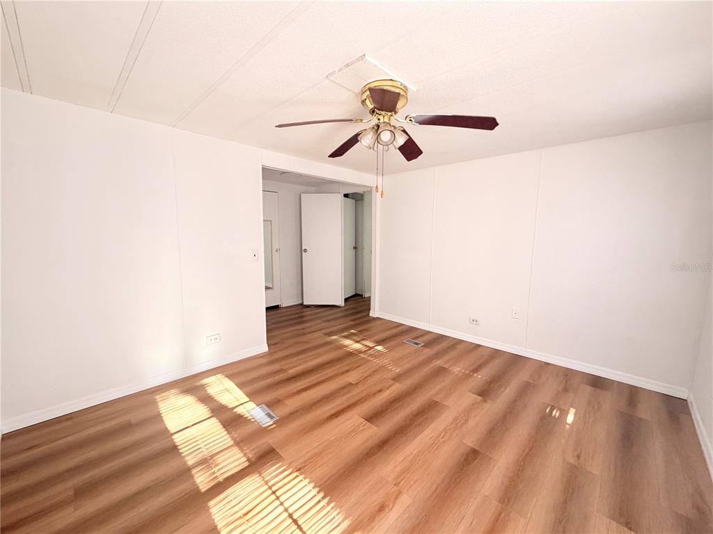 26352 Mc Allister Street Brooksville, FL 34602 - Photo 15 of 26 a view of empty room with wooden floor
