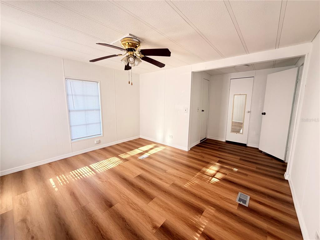 26352 Mc Allister Street Brooksville, FL 34602 - Photo 16 of 26 a view of empty room with wooden floor