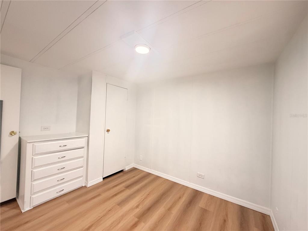 26352 Mc Allister Street Brooksville, FL 34602 - Photo 22 of 26 a view of an empty room and wooden floor