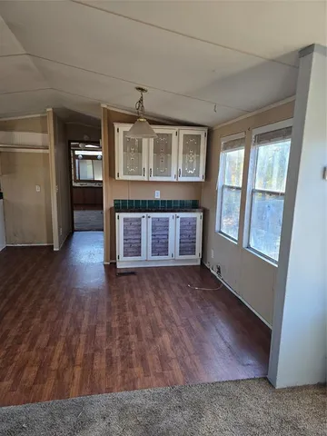 a kitchen with granite countertop white cabinets and white appliances