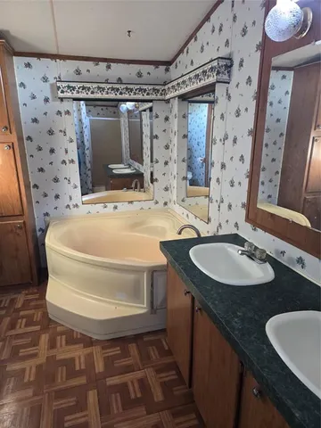 a bathroom with mirror sink and vanity