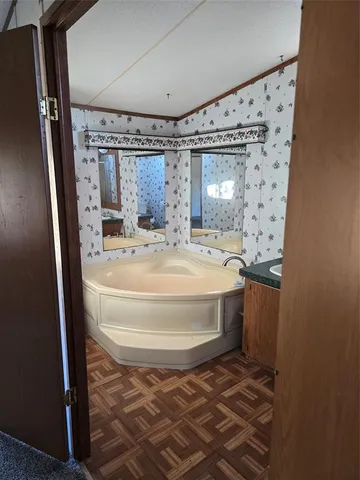 a bathroom with a granite countertop toilet a sink and a mirror
