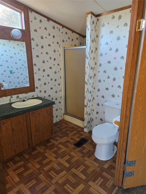 1903 VZ County Road Ben Wheeler, TX 75754 - Photo 28 of 35 a bathroom with a granite countertop toilet a sink and a mirror