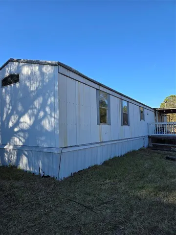 a view of a yard with wooden fence