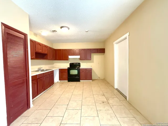 a large kitchen with a large counter top and appliances