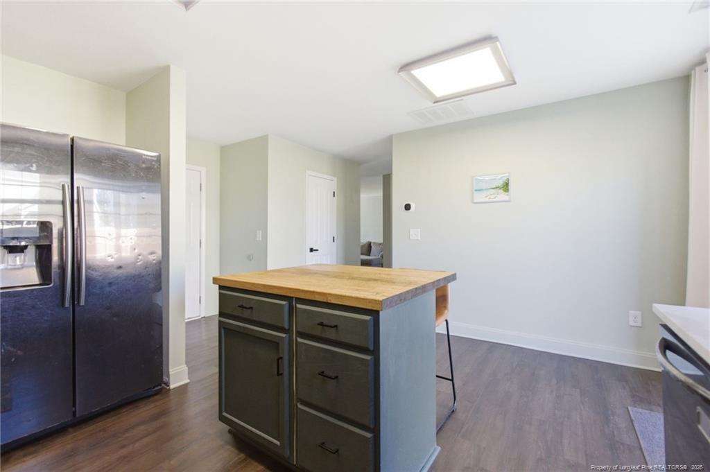334 Crane Way Bunnlevel, NC 28323 - Photo 13 of 45 a kitchen with a granite countertop kitchen island wooden floor and refrigerator