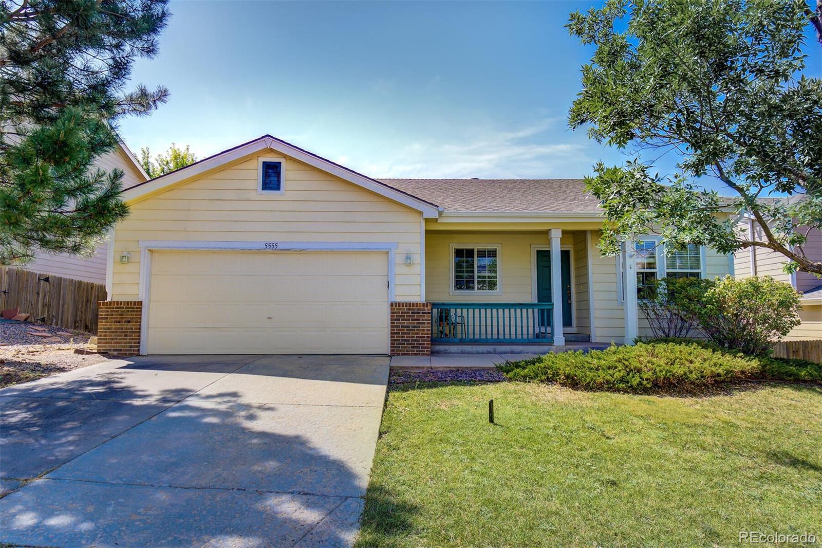5555 South Rome Street Aurora, CO 80015 - Photo 1 of 34 a front view of house with yard and trees in the background