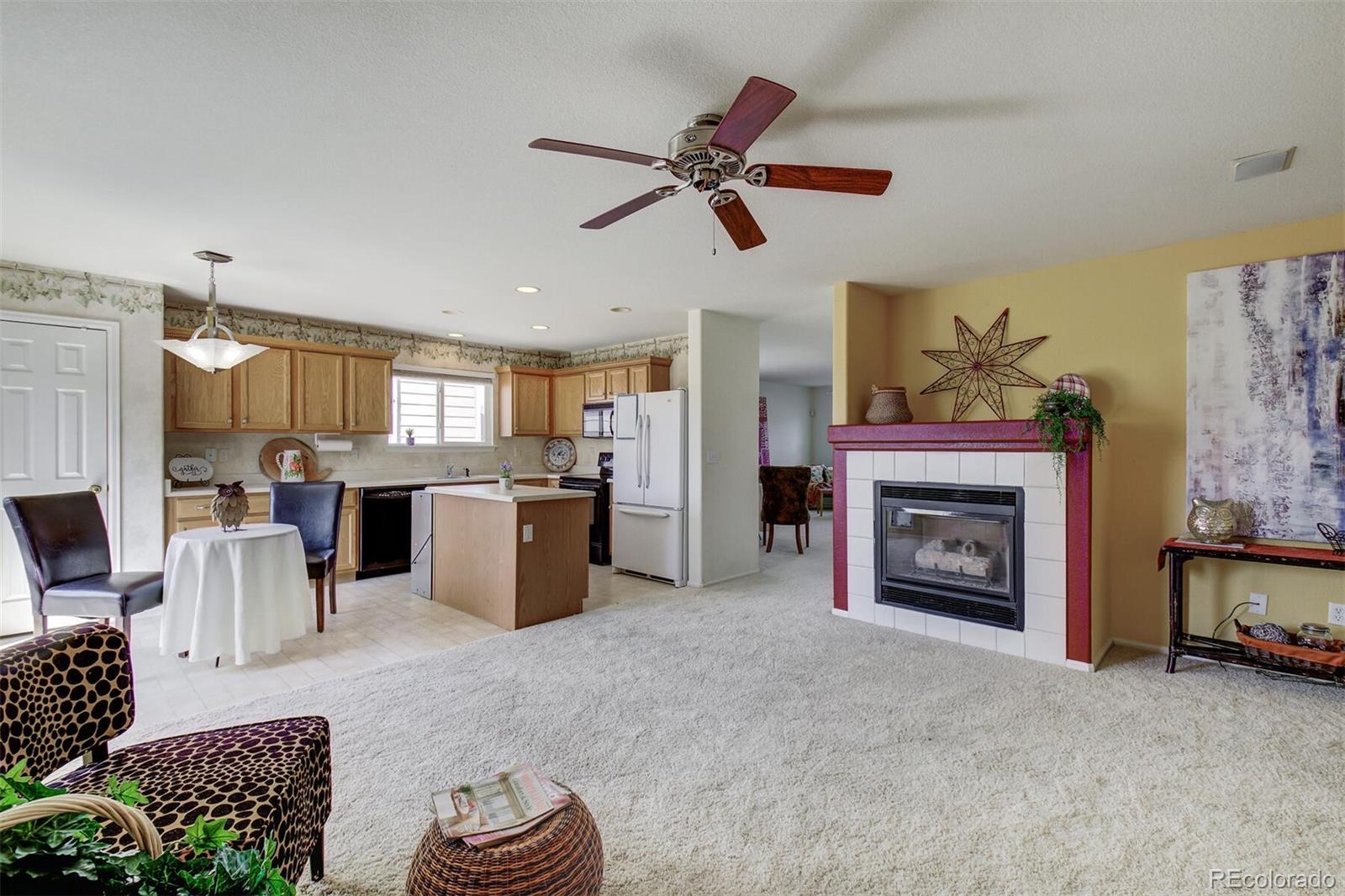 5555 South Rome Street Aurora, CO 80015 - Photo 15 of 34 a living room with furniture and a fireplace