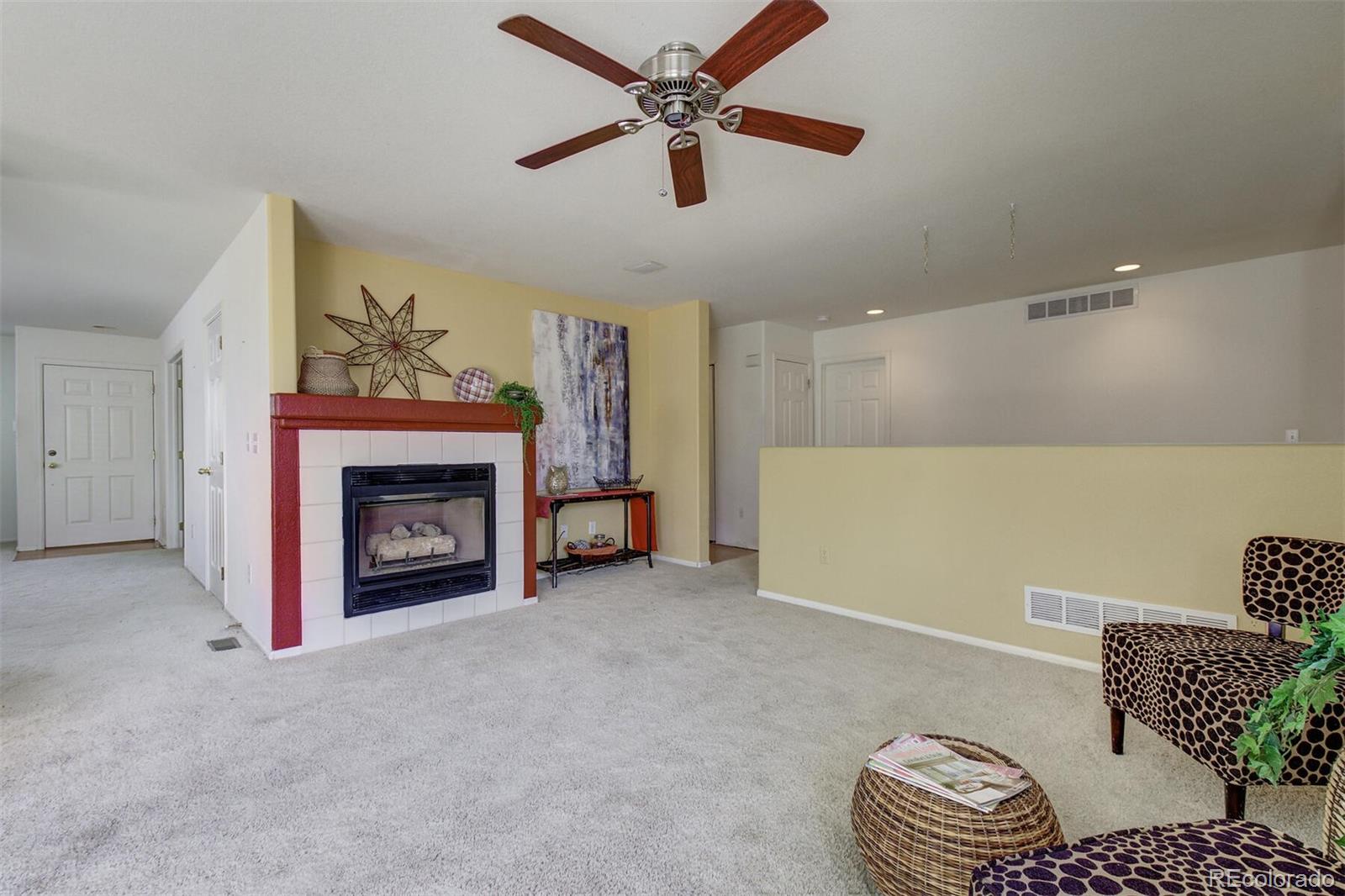5555 South Rome Street Aurora, CO 80015 - Photo 16 of 34 a living room with furniture and a fireplace