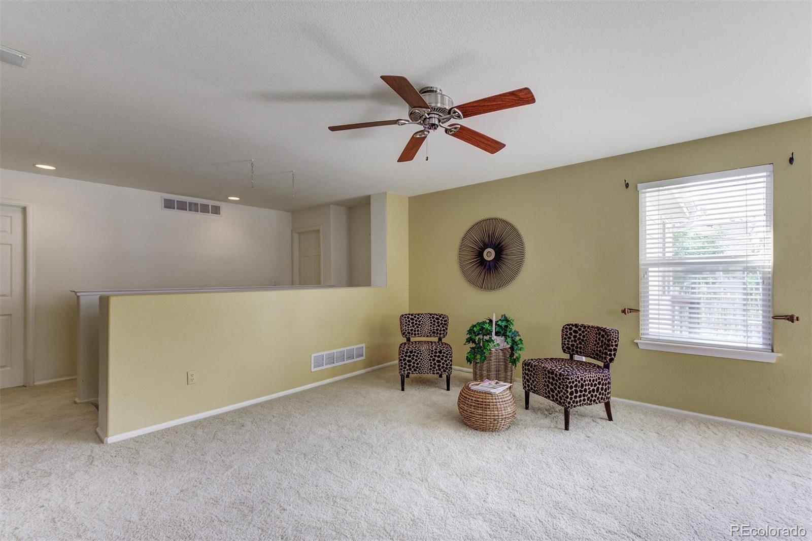 5555 South Rome Street Aurora, CO 80015 - Photo 17 of 34 a living room with furniture and a window