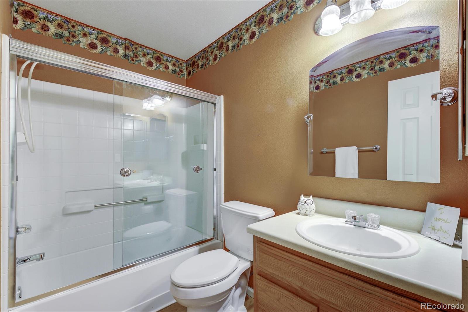 5555 South Rome Street Aurora, CO 80015 - Photo 25 of 34 a bathroom with a sink a toilet and shower
