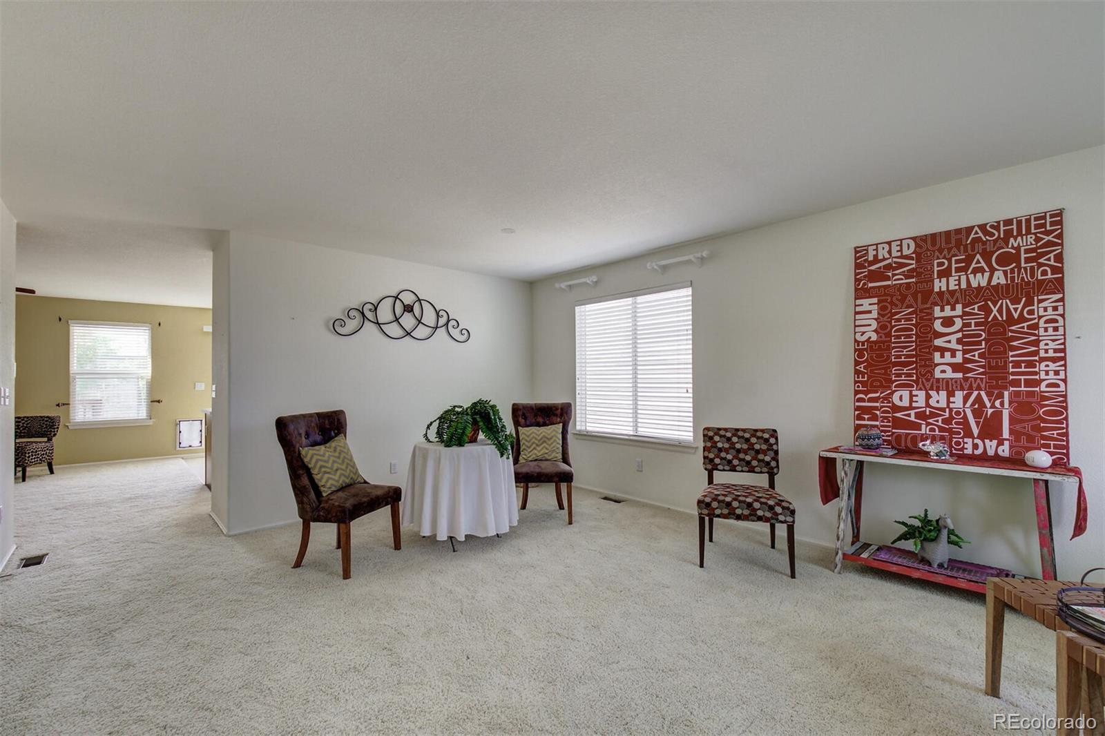 5555 South Rome Street Aurora, CO 80015 - Photo 3 of 34 a view of a livingroom with furniture and a window