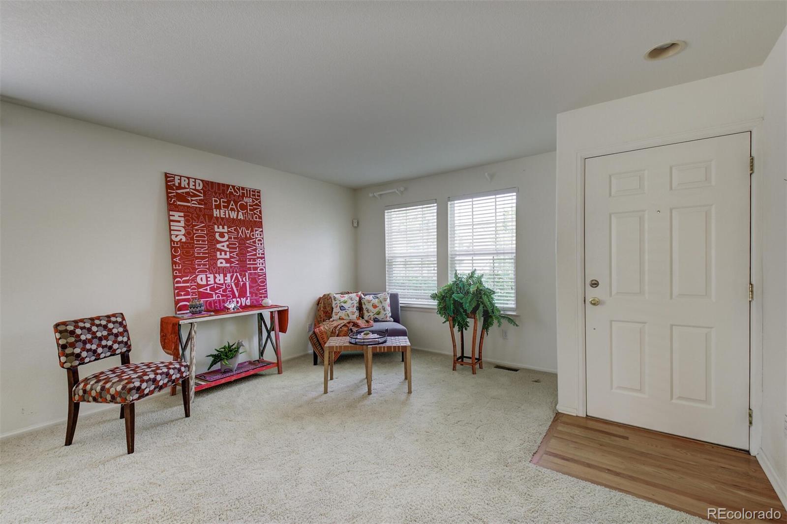 5555 South Rome Street Aurora, CO 80015 - Photo 4 of 34 a living room with furniture and a potted plant