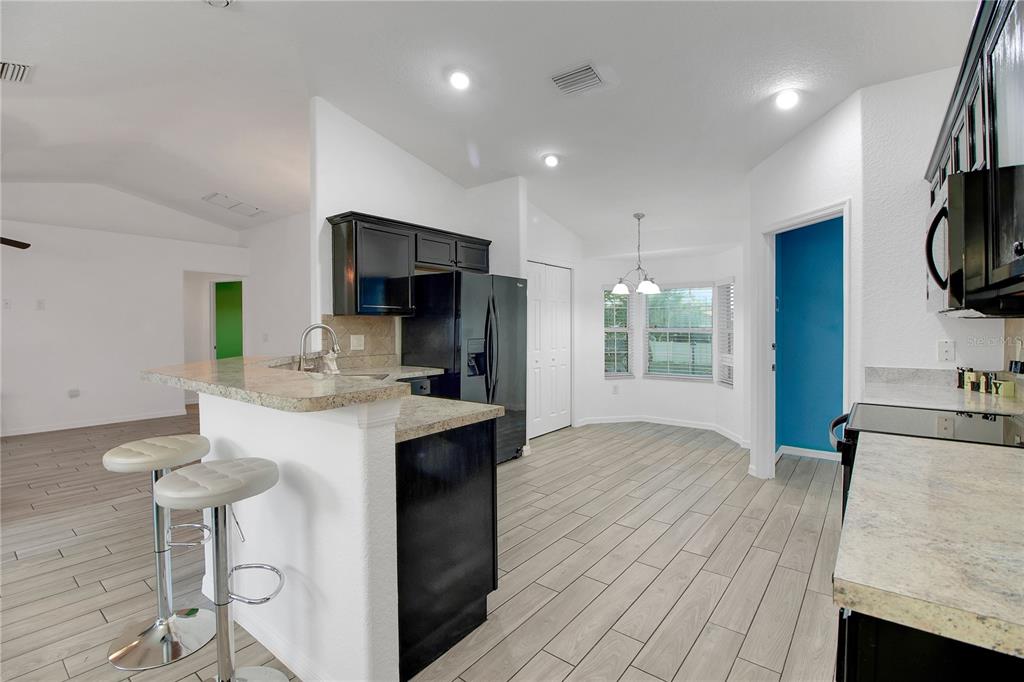 314 Stone Castle Loop Lady Lake, FL 32159 - Photo 15 of 42 a kitchen with stainless steel appliances a sink stove and refrigerator