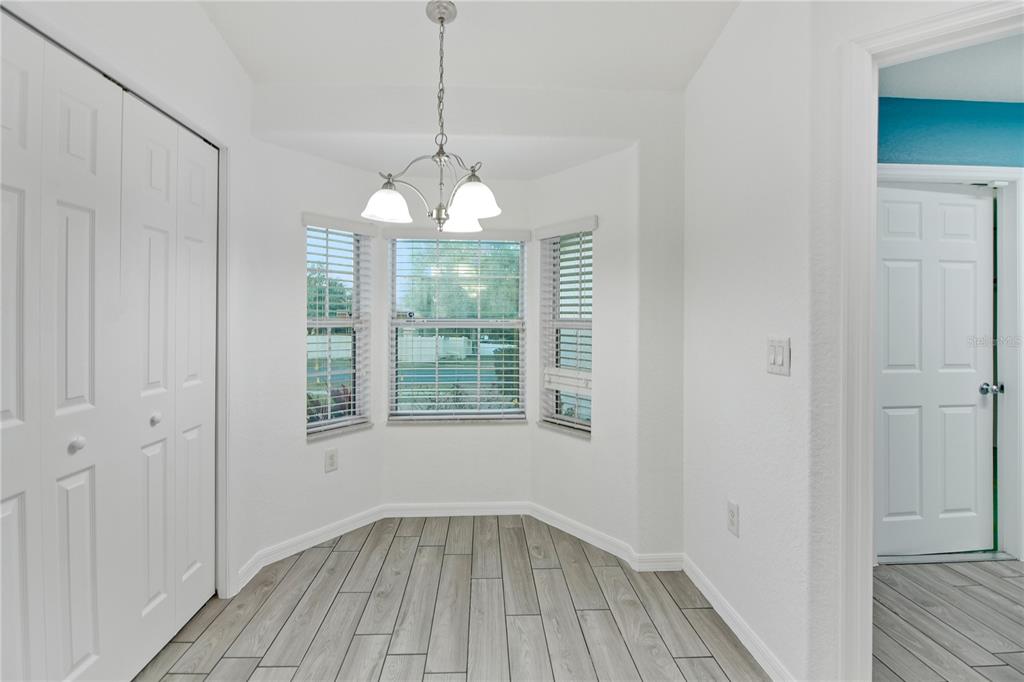 314 Stone Castle Loop Lady Lake, FL 32159 - Photo 17 of 42 a view of an empty room with wooden floor and a window