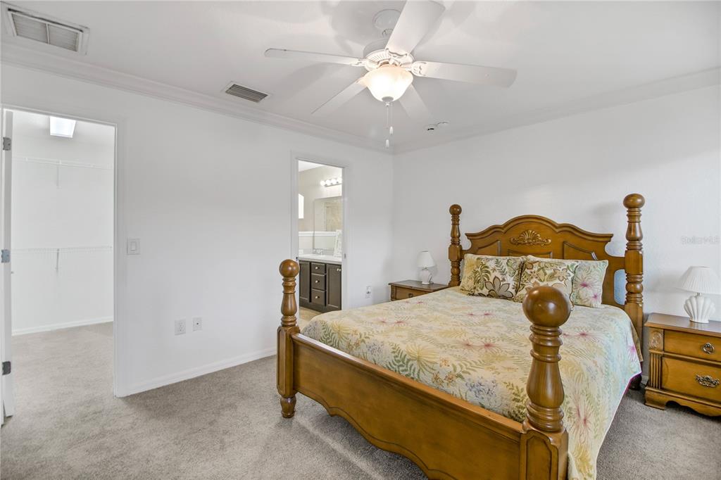 314 Stone Castle Loop Lady Lake, FL 32159 - Photo 20 of 42 a bedroom with a bed and a ceiling fan