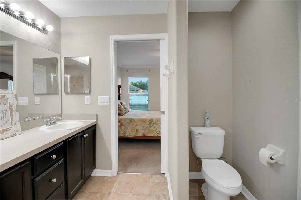314 Stone Castle Loop Lady Lake, FL 32159 - Photo 25 of 42 a spacious bathroom with a double vanity sink toilet and shower