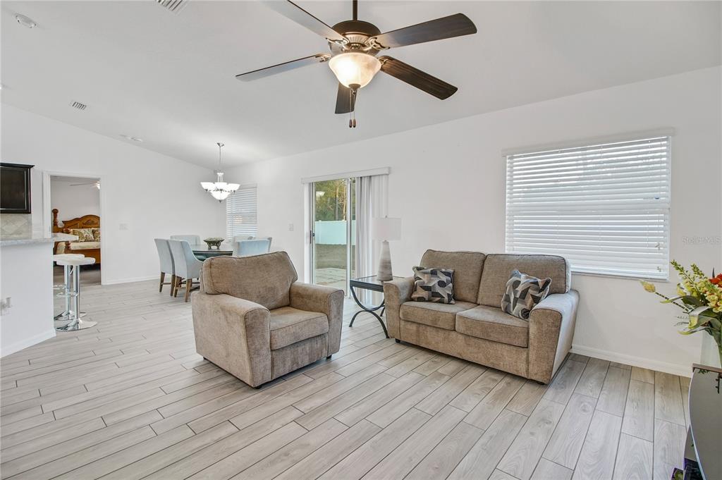 314 Stone Castle Loop Lady Lake, FL 32159 - Photo 30 of 42 a living room with furniture and a wooden floor