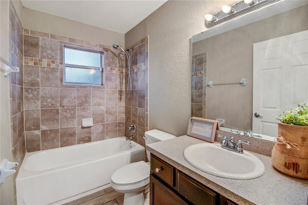 314 Stone Castle Loop Lady Lake, FL 32159 - Photo 35 of 42 a bathroom with a sink a toilet and bathtub