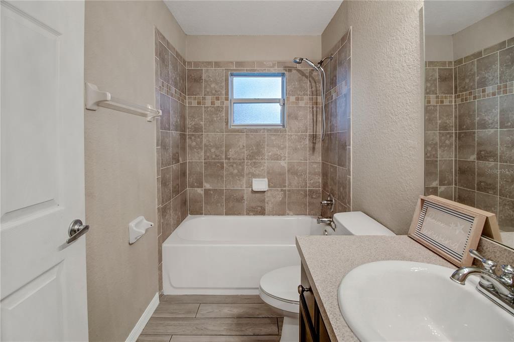 314 Stone Castle Loop Lady Lake, FL 32159 - Photo 36 of 42 a bathroom with a sink a toilet and shower