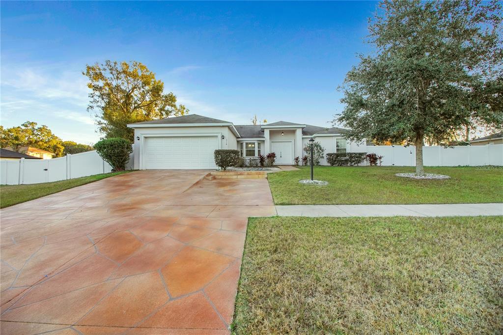 314 Stone Castle Loop Lady Lake, FL 32159 - Photo 4 of 42 a view of a house with a yard and garage