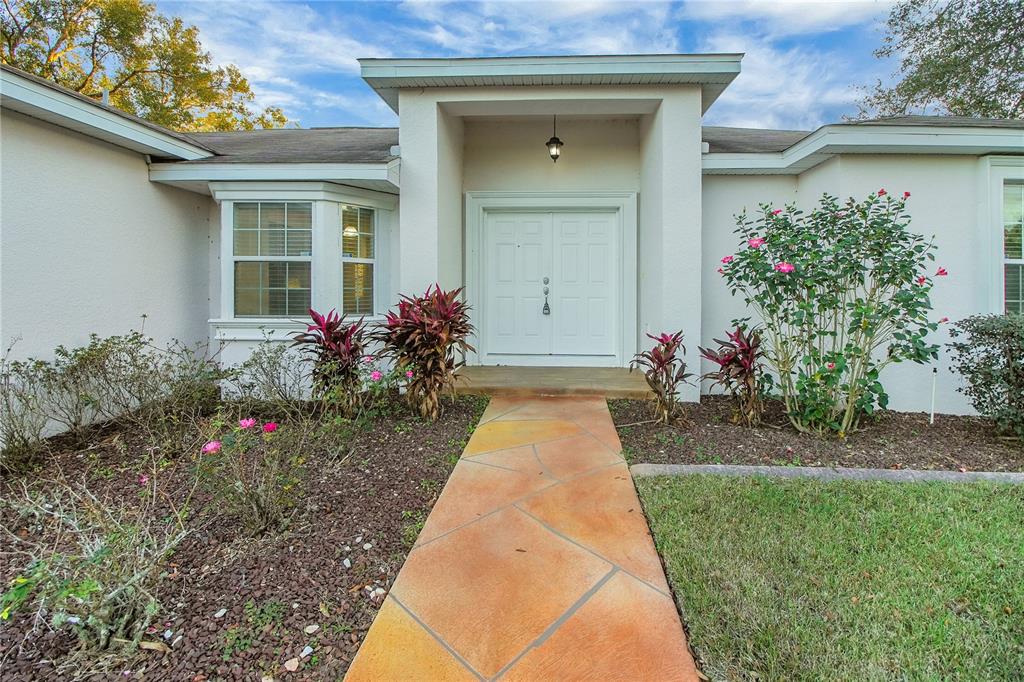 314 Stone Castle Loop Lady Lake, FL 32159 - Photo 6 of 42 a front view of a house with a yard