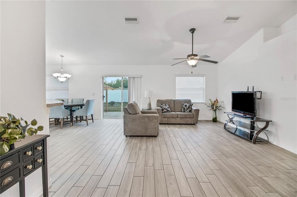 314 Stone Castle Loop Lady Lake, FL 32159 - Photo 8 of 42 a living room with furniture and a flat screen tv